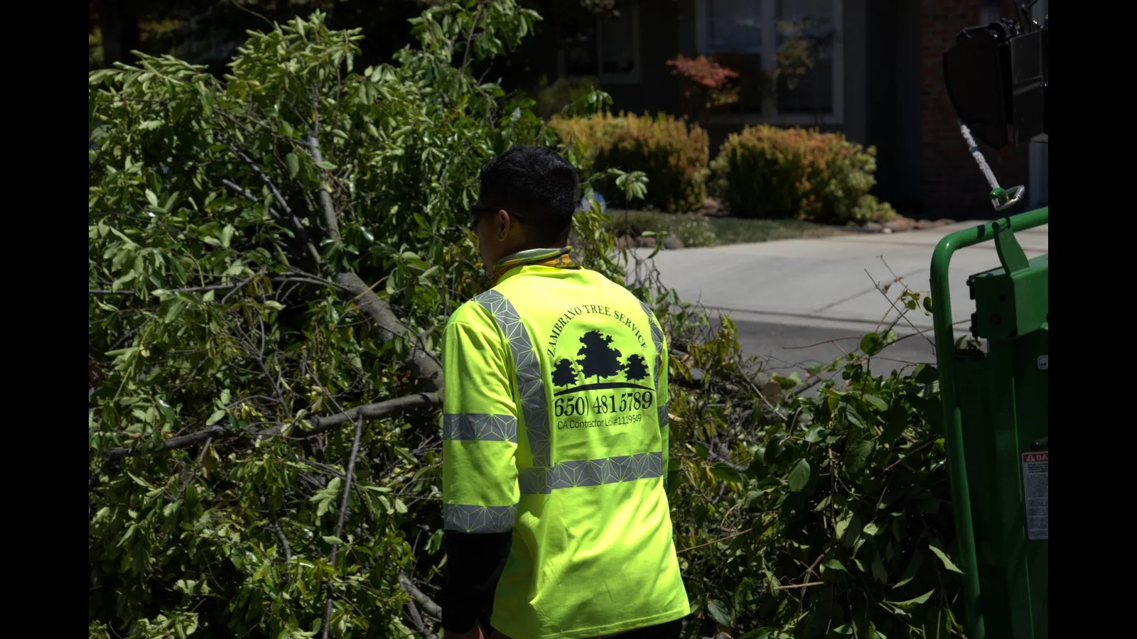 Zambrano Tree Service crew member in branded high-visibility uniform