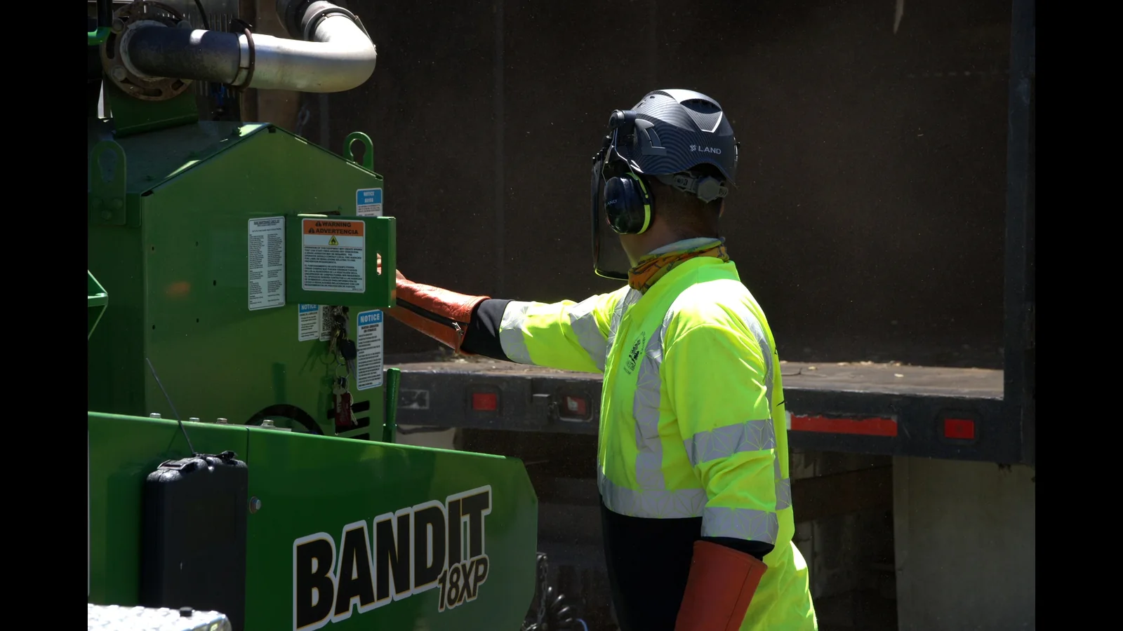 Zambrano crew member operating a Bandit 18XP wood chipper